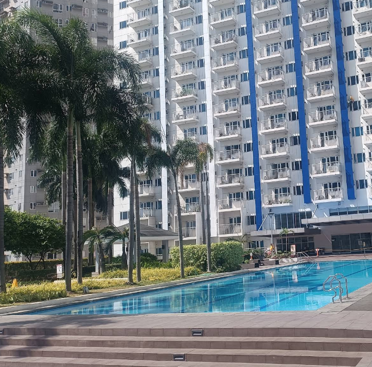Modern residential condo towers under a warm afternoon sky